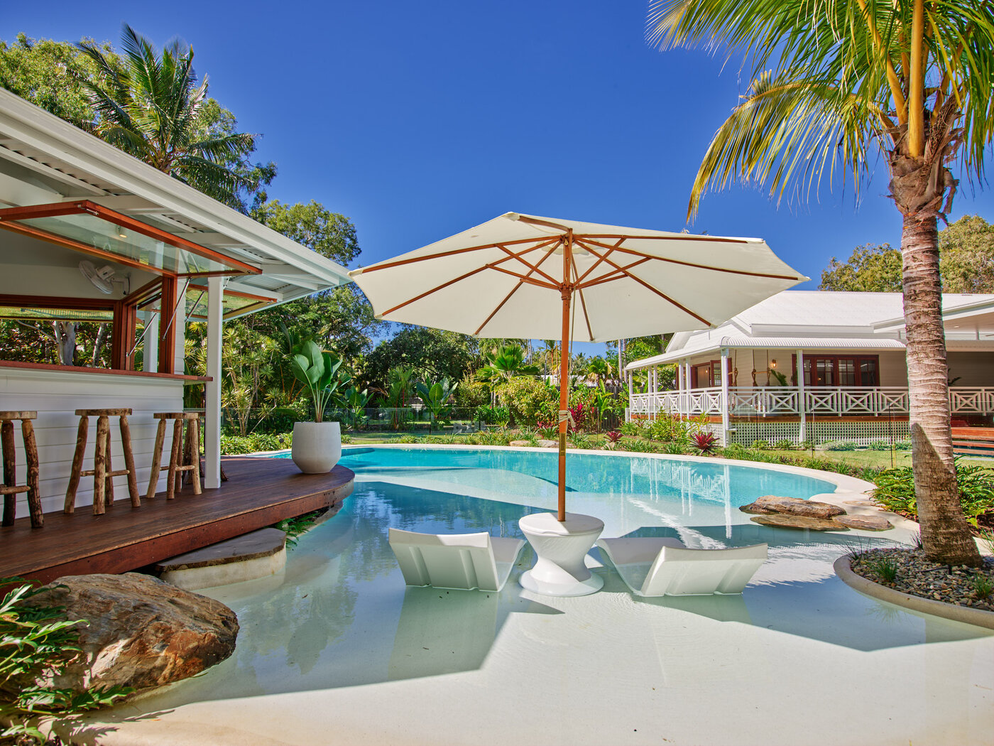 Custom Designed Resort Style Pool with Umbrella, pool chairs and palm trees