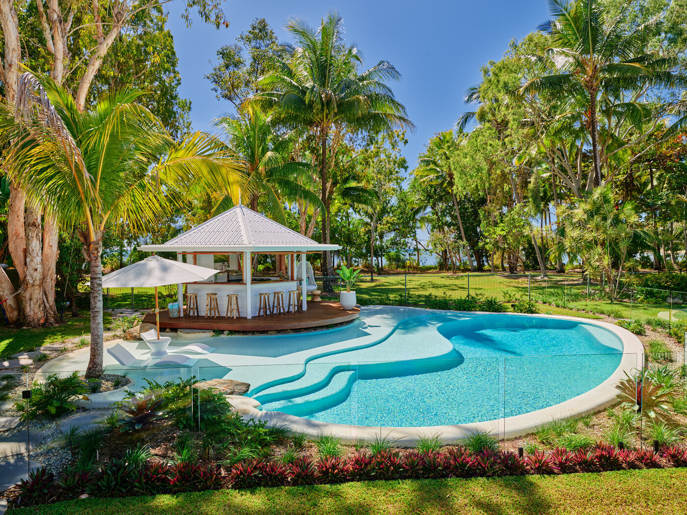 Custom Designed Resort Style Pool with Umbrella, pool chairs and palm trees