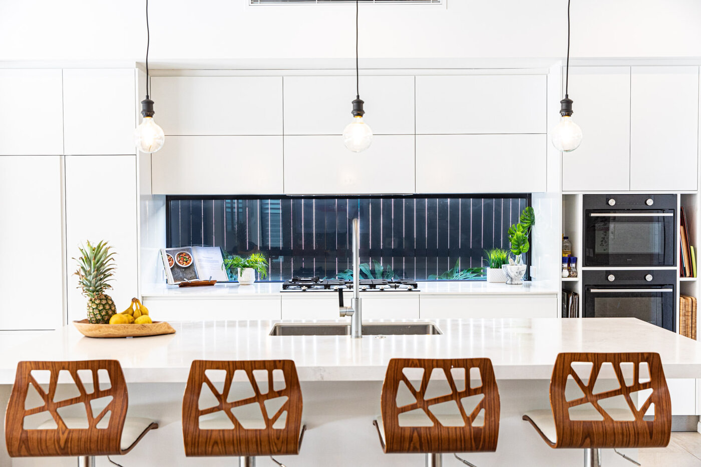 Luxury kitchen with bar stools and pendants at an island bench